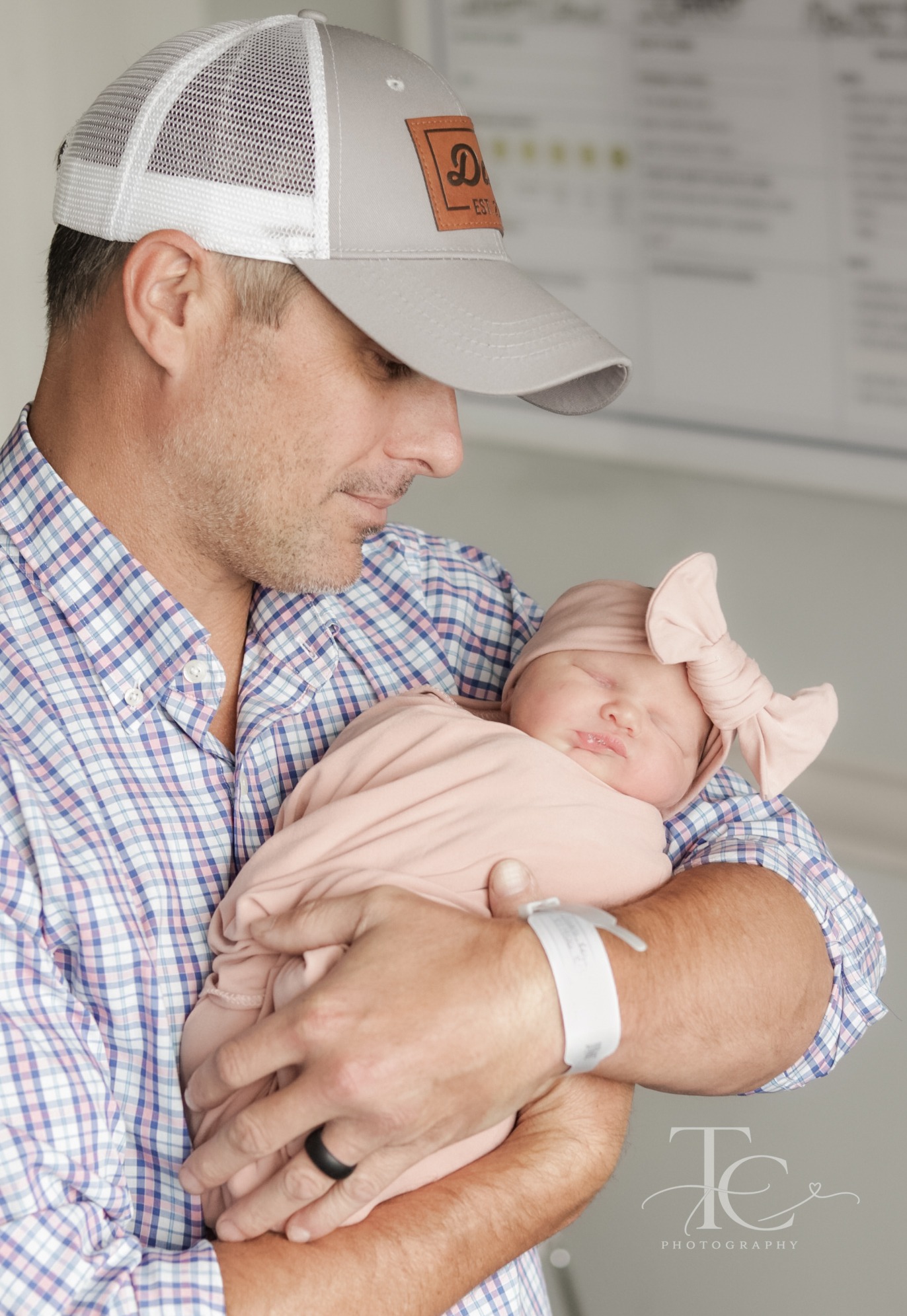 Father cuddling his newborn in the hospital