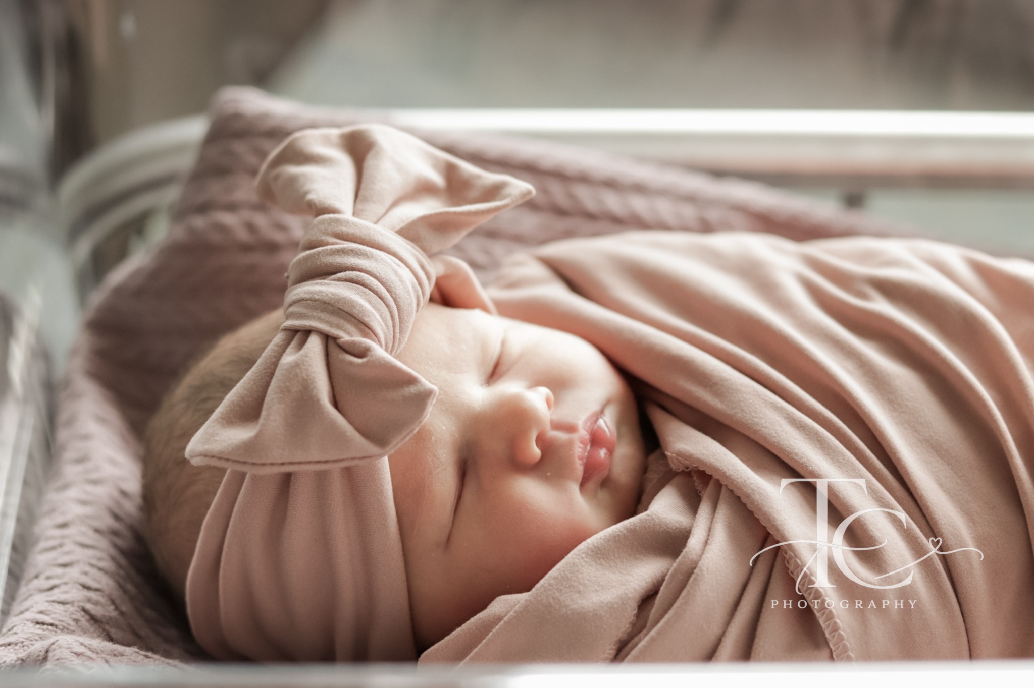 Sleeping newborn resting in a hospital bassinet