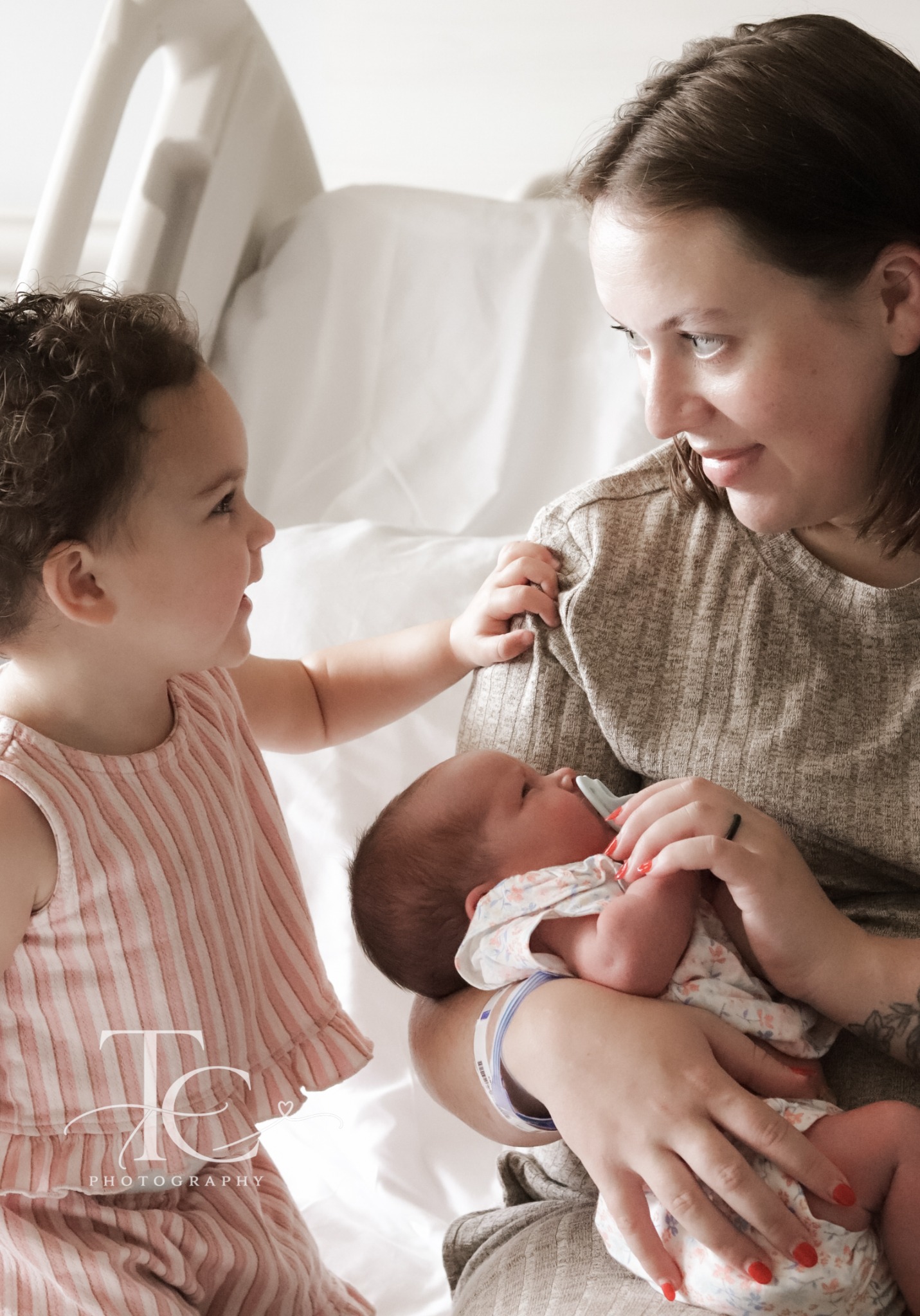 Mother and daughter together with newborn