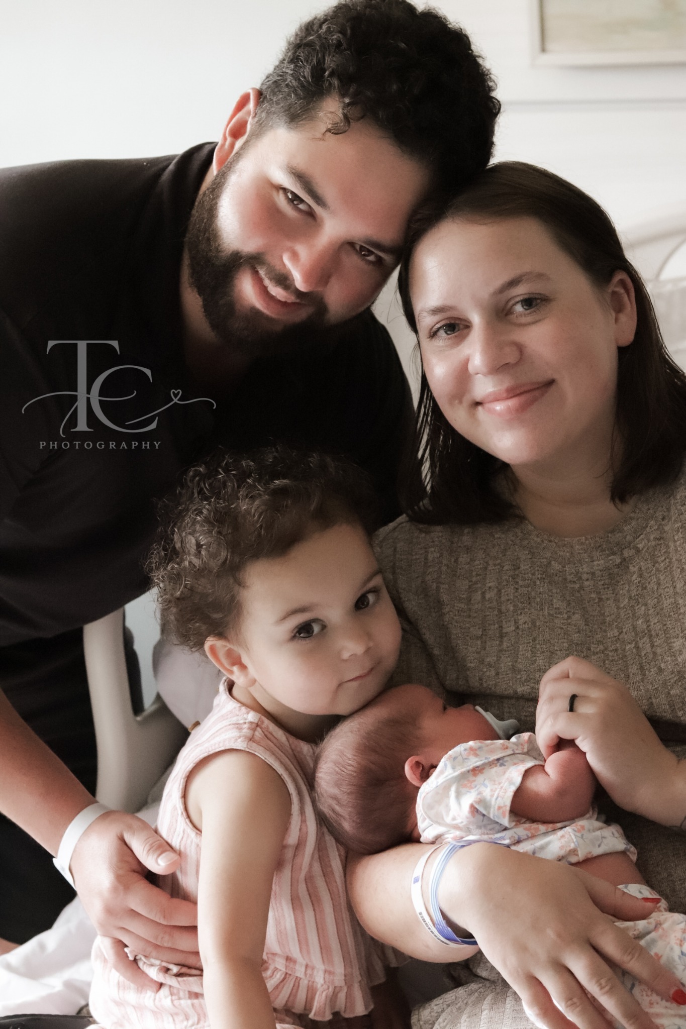Family gathered together with their newborn