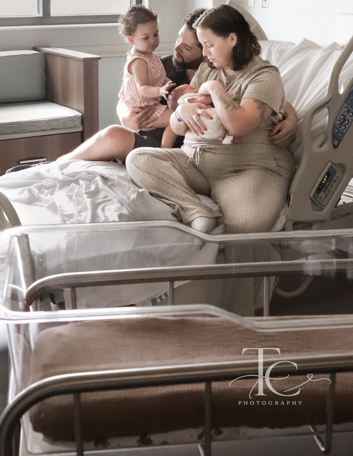 Mother and children together on a hospital bed