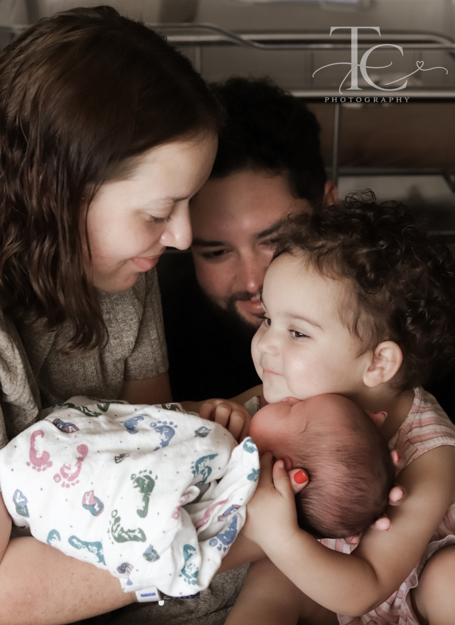 Family sharing a quiet cuddle with their newborn