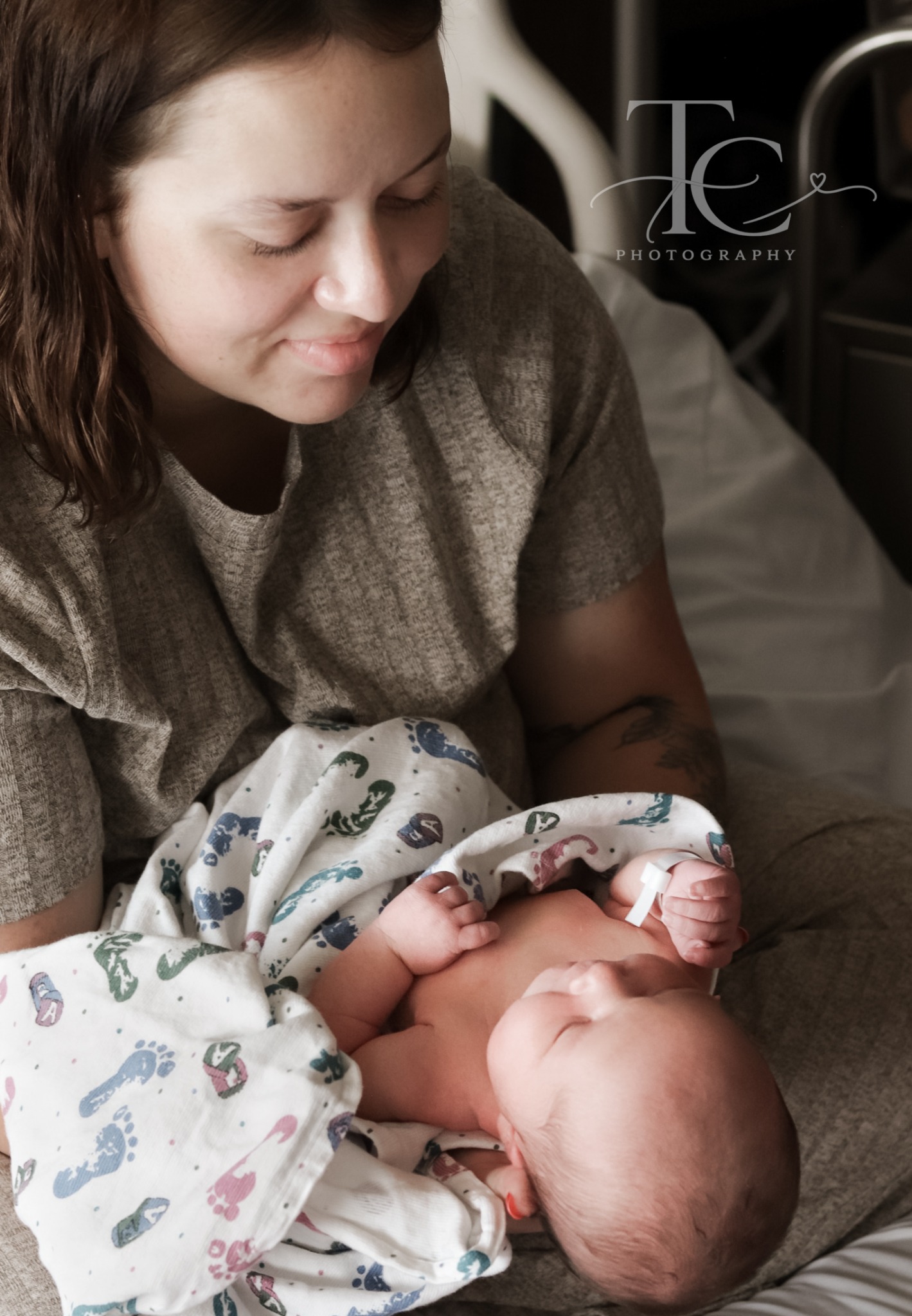 Mother gazing lovingly at her newborn