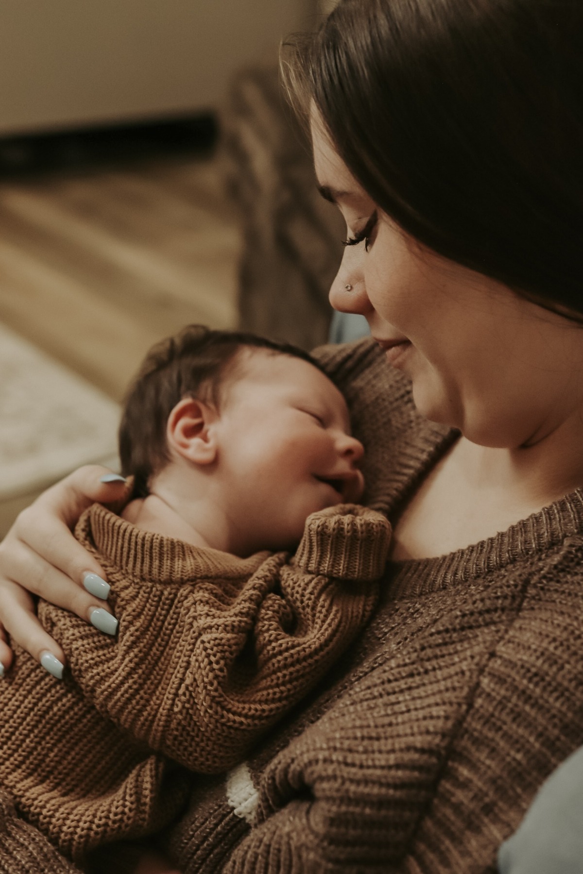 Mother holding her sleeping newborn close to her chest