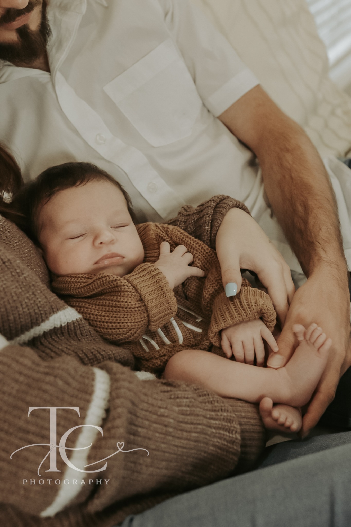 Father gently kissing his newborn