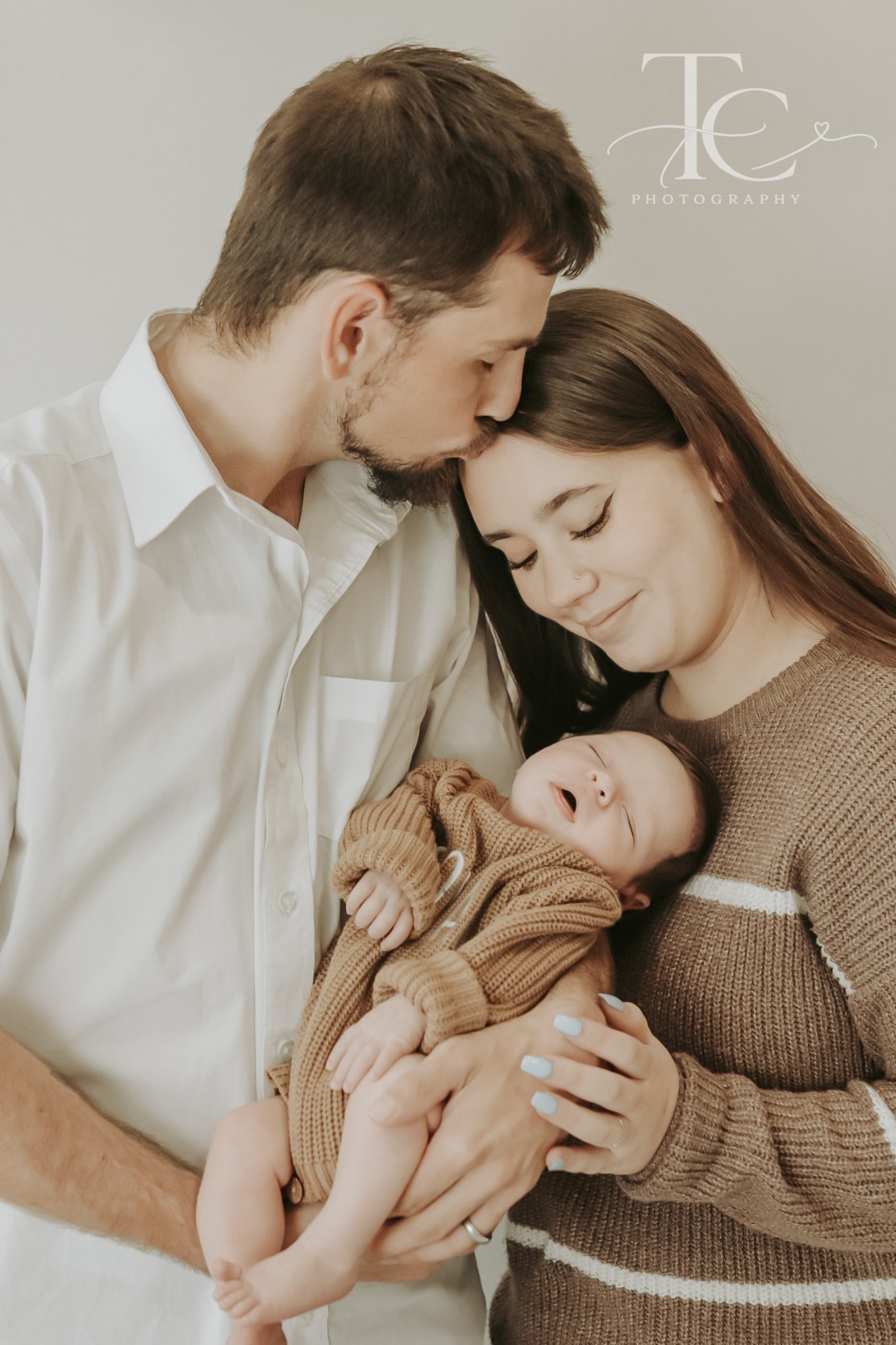 Mother looking lovingly at her sleeping newborn