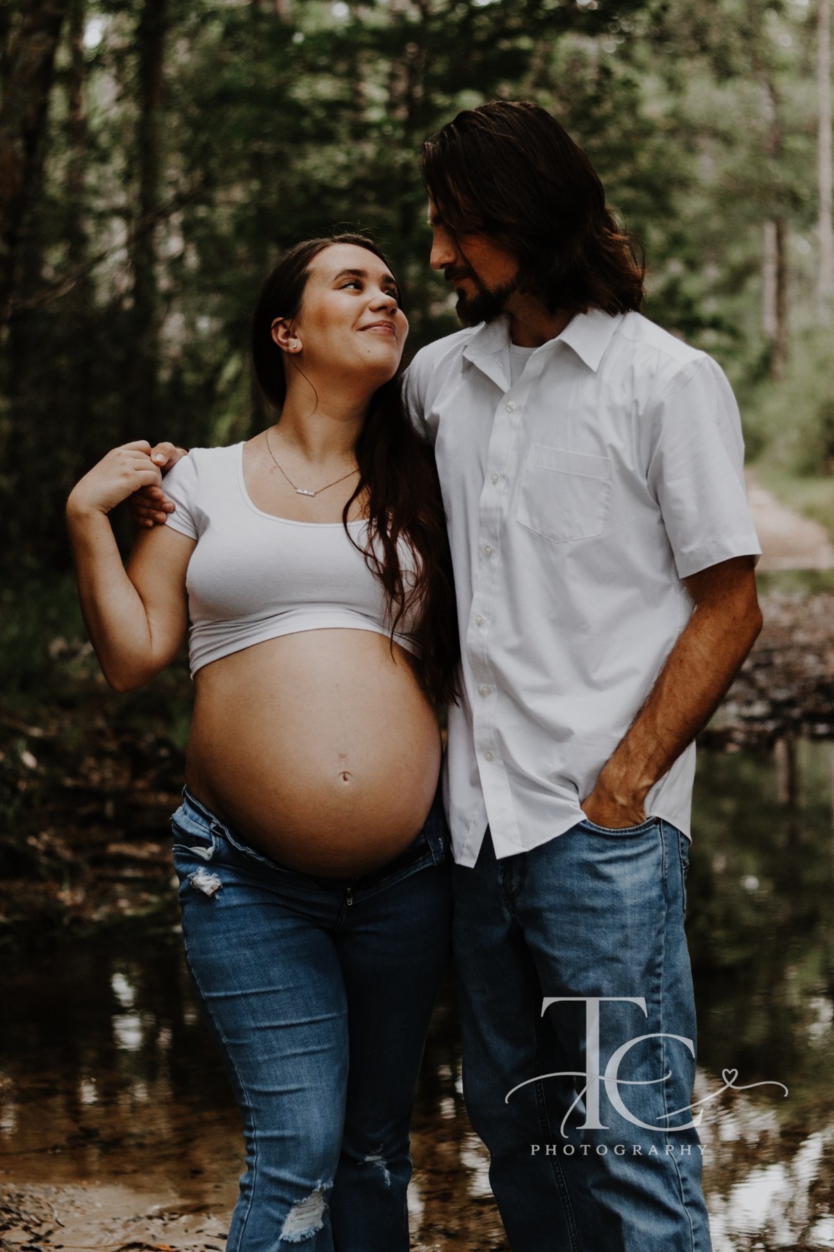 Couple standing close together during their maternity session