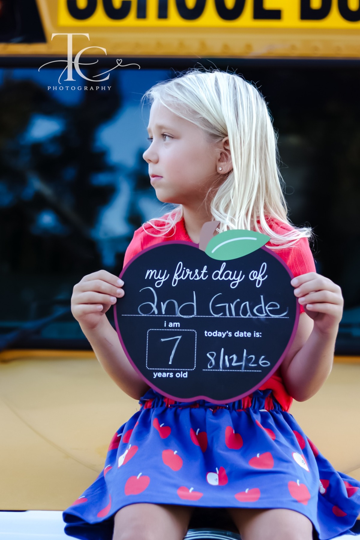 Girl holding a first day of school sign